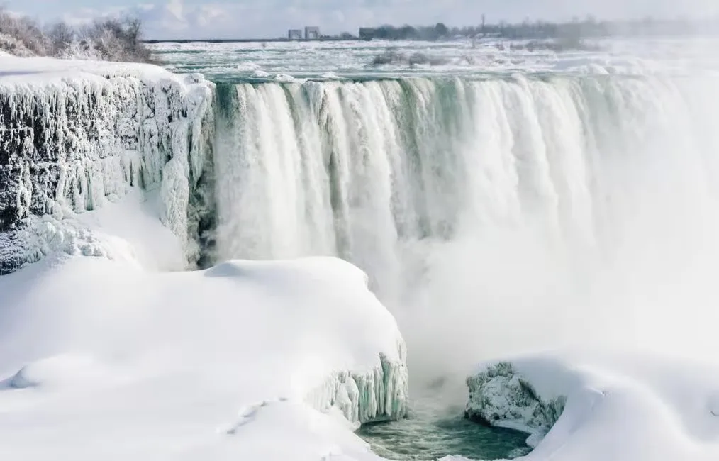 Niagara Falls in winter with ice and snow covering the landscape